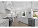 Stunning kitchen with white shaker cabinets, a farmhouse sink, and stainless steel appliances at 5755 Carriage Dr, Sarasota, FL 34243