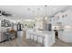 Bright kitchen boasts white cabinets, a large island, and stainless steel appliances at 5755 Carriage Dr, Sarasota, FL 34243