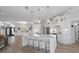 Open concept kitchen with white cabinets, island with seating, and hardwood floors at 5755 Carriage Dr, Sarasota, FL 34243