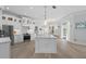 Spacious kitchen featuring white cabinets, a large island, and stainless steel appliances at 5755 Carriage Dr, Sarasota, FL 34243