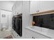 Laundry room with washer, dryer, and extra storage cabinets at 5755 Carriage Dr, Sarasota, FL 34243