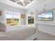 Main bedroom with backyard access and large TV at 5755 Carriage Dr, Sarasota, FL 34243