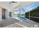 Screened-in pool and patio area overlooking a tranquil lake at 5755 Carriage Dr, Sarasota, FL 34243