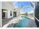 Relaxing pool area with screened enclosure and brick pavers at 5755 Carriage Dr, Sarasota, FL 34243