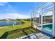 Pool area with screened enclosure and pond view at 5755 Carriage Dr, Sarasota, FL 34243