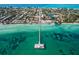 Aerial view of coastal town with beach, pier, and turquoise water at 6506 Gulf Dr, Holmes Beach, FL 34217