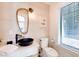 Contemporary bathroom with a vessel sink, unique mirror, and neutral tile at 6506 Gulf Dr, Holmes Beach, FL 34217
