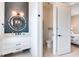 Clean bathroom with vanity, toilet and access to bedroom at 6506 Gulf Dr, Holmes Beach, FL 34217