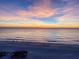 Stunning sunset over the ocean and sandy beach at 6506 Gulf Dr, Holmes Beach, FL 34217