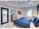 Guest bedroom with private balcony access and a TV at 6506 Gulf Dr, Holmes Beach, FL 34217