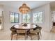 Elegant dining room with large round table and chandelier at 6506 Gulf Dr, Holmes Beach, FL 34217