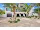Two-story home with modern design, landscaped grounds, and a two-car garage at 6506 Gulf Dr, Holmes Beach, FL 34217