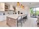 Modern kitchen with island, white cabinets, and quartz countertops at 6506 Gulf Dr, Holmes Beach, FL 34217