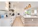 Bright kitchen featuring white cabinetry and a spacious island at 6506 Gulf Dr, Holmes Beach, FL 34217