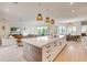Open concept kitchen with island and views into living area at 6506 Gulf Dr, Holmes Beach, FL 34217