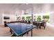 Covered patio with ping pong table, comfortable seating, and pool view at 6506 Gulf Dr, Holmes Beach, FL 34217
