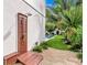 Private outdoor shower with wooden enclosure and pebble stone pathway at 6506 Gulf Dr, Holmes Beach, FL 34217