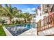 Inviting pool with spacious deck, lush landscaping, and modern staircase at 6506 Gulf Dr, Holmes Beach, FL 34217