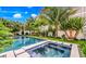 Relaxing pool and spa with lush tropical landscaping at 6506 Gulf Dr, Holmes Beach, FL 34217