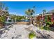 Landscaped backyard with waterfront access and pathway at 671 Emerald Harbor Dr, Longboat Key, FL 34228