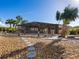 Pathway through a stone-covered backyard leading to a screened patio at 671 Emerald Harbor Dr, Longboat Key, FL 34228