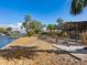 Backyard with stone pathway, leading to a screened pool area at 671 Emerald Harbor Dr, Longboat Key, FL 34228