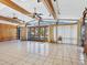 Large living room with pool view and wood beams at 671 Emerald Harbor Dr, Longboat Key, FL 34228