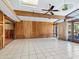 Large living area with wood paneling and pool view at 671 Emerald Harbor Dr, Longboat Key, FL 34228