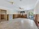 Large living room with water damage and needs renovation at 671 Emerald Harbor Dr, Longboat Key, FL 34228