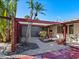 Brick paved patio with wooden pergola and tropical landscaping at 671 Emerald Harbor Dr, Longboat Key, FL 34228