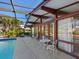 Relaxing poolside patio with screened enclosure overlooking canal at 671 Emerald Harbor Dr, Longboat Key, FL 34228