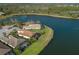 An aerial view of well-manicured lawns leading to tranquil lakefront properties with tile roofs and screened patios at 7115 Callander Cv, Lakewood Ranch, FL 34202