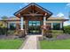 Stunning clubhouse entrance boasts stone accents, and beautiful landscaping leading to double glass doors at 7115 Callander Cv, Lakewood Ranch, FL 34202