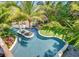 Aerial view of a unique, lagoon-style pool and spa at 9403 Gulf Dr, Anna Maria, FL 34216