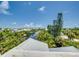 Aerial view showcasing canal and lush landscaping at 9403 Gulf Dr, Anna Maria, FL 34216