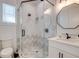 Bathroom with hexagon-tiled shower, modern vanity and fixtures at 9403 Gulf Dr, Anna Maria, FL 34216