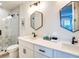 Modern bathroom with double vanity, hexagon tile shower, and stylish mirrors at 9403 Gulf Dr, Anna Maria, FL 34216
