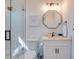 Bathroom with a walk-in shower and octagonal mirror at 9403 Gulf Dr, Anna Maria, FL 34216