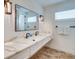 Double vanity bathroom with quartz countertop and patterned floor at 9403 Gulf Dr, Anna Maria, FL 34216