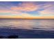 Stunning sunset over a tranquil beach scene at 9403 Gulf Dr, Anna Maria, FL 34216
