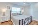 Bedroom with queen-size bed, wood floors, and white nightstands at 9403 Gulf Dr, Anna Maria, FL 34216