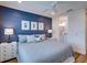Bedroom with king-size bed, blue shiplap wall, and white nightstands at 9403 Gulf Dr, Anna Maria, FL 34216