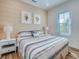 Bedroom with king-size bed, striped bedding, and wood floors at 9403 Gulf Dr, Anna Maria, FL 34216