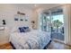 Bright bedroom with king-size bed and sliding doors to balcony at 9403 Gulf Dr, Anna Maria, FL 34216