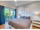 Bedroom with king-size bed, wood floors, and access to balcony at 9403 Gulf Dr, Anna Maria, FL 34216