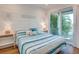 Bedroom with a queen-size bed and access to a private balcony at 9403 Gulf Dr, Anna Maria, FL 34216