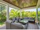 Relaxing covered patio with wicker furniture and tropical views at 9403 Gulf Dr, Anna Maria, FL 34216