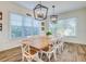 Large dining room with farmhouse table and six chairs at 9403 Gulf Dr, Anna Maria, FL 34216