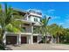 Stunning two-story home with a spacious driveway and lush landscaping at 9403 Gulf Dr, Anna Maria, FL 34216