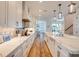 Modern kitchen boasting white cabinets and a large island with quartz countertops at 9403 Gulf Dr, Anna Maria, FL 34216